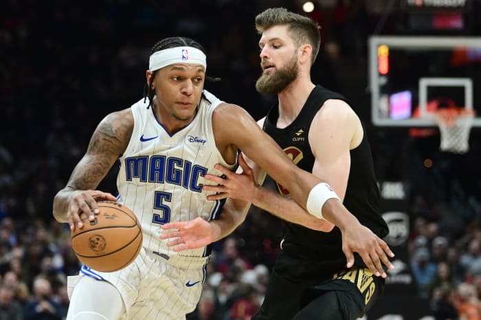 Orlando Magic forward Paolo Banchero (5) drives past Cleveland Cavaliers forward Dean Wade